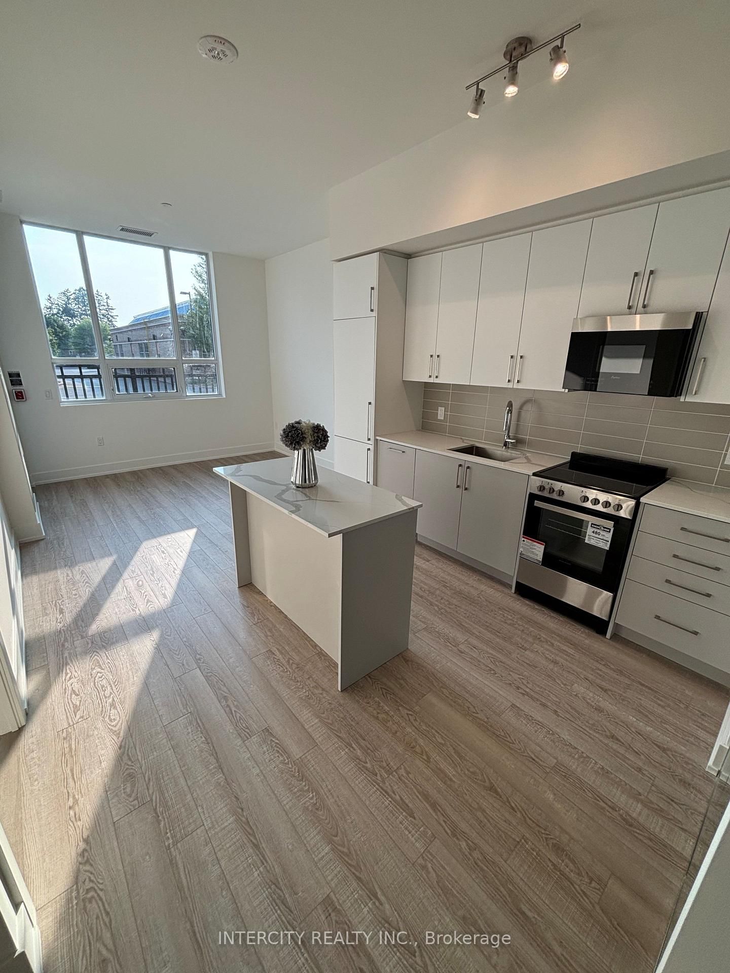 Welcome to upscale living at King Terraces. This elegant west-facing 2-bedroom, 2-bathroom suite offers a total of 810 sq.ft. (698 sq.ft. interior, plus 112 sq. ft. outdoor terrace overlooking landscaped walkway with natural gas BBQ hookup). Thoughtfully designed space features a split-bedroom layout that blends privacy, comfort, and contemporary luxury. Bask in beautiful afternoon light through expansive west-facing windows with extra high 10-foot ceilings and premium vinyl plank flooring throughout, creating a sleek, open atmosphere. The heart of the home is a modern Kitchen with a stylish island, integrated appliances, and quartz countertops- ideal for cooking, entertaining or gathering friends. The primary bedroom is generously sized and features a walk-in shower ensuite, while the second bedroom is perfect for guests, an office or shared living, with easy access to a fully second bathroom. Enjoy the added value of underground parking and storage locker. Residents of King Terraces have access to a curated collection of 5-star amenities, including a fully equipped fitness centre, rooftop terrace, resort-style outdoor pool, chic party lounge, and 24-hour concierge- all designed to elevate everyday. Perfectly located near dining, shopping, green spaces, and transit (including the nearby GO King Station). This luxurious suite offers exceptional comfort, convenience and community.