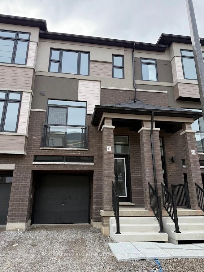 Experience contemporary luxury living in this brand-new, never-lived-in corner freehold townhouse at Brantford's prestigious Electric Grand community-a stunning semi-detached end unit spanning 1408 sq ft across 3 stories on a premium walk-out ravine lot backing lush green space for ultimate privacy and serenity. Thoughtfully designed with 9-foot ceilings, expansive windows flooding natural light throughout, high-end laminate floors on the main level, a sleek contemporary kitchen boasting elegant cabinetry, brand-new stainless steel appliances, and balcony access from dining/kitchen areas, plus window coverings throughout, this turn-key gem offers effortless style. The luxurious primary suite features a walk-in closet, additional storage, and a private ensuite, complemented by two generous secondary bedrooms, a second full bath on the third floor, main-floor laundry, stylish powder room, fully finished walk-out basement with garage access, and a modern brick-and-stucco exterior. Perfectly positioned near the Grand River, scenic parks/trails, top schools, shopping, Wilfrid Laurier University, and Highways 403/401, this walkable West Brant family haven delivers unbeatable convenience, modern comfort, and natural beauty. Your ideal rental awaits.