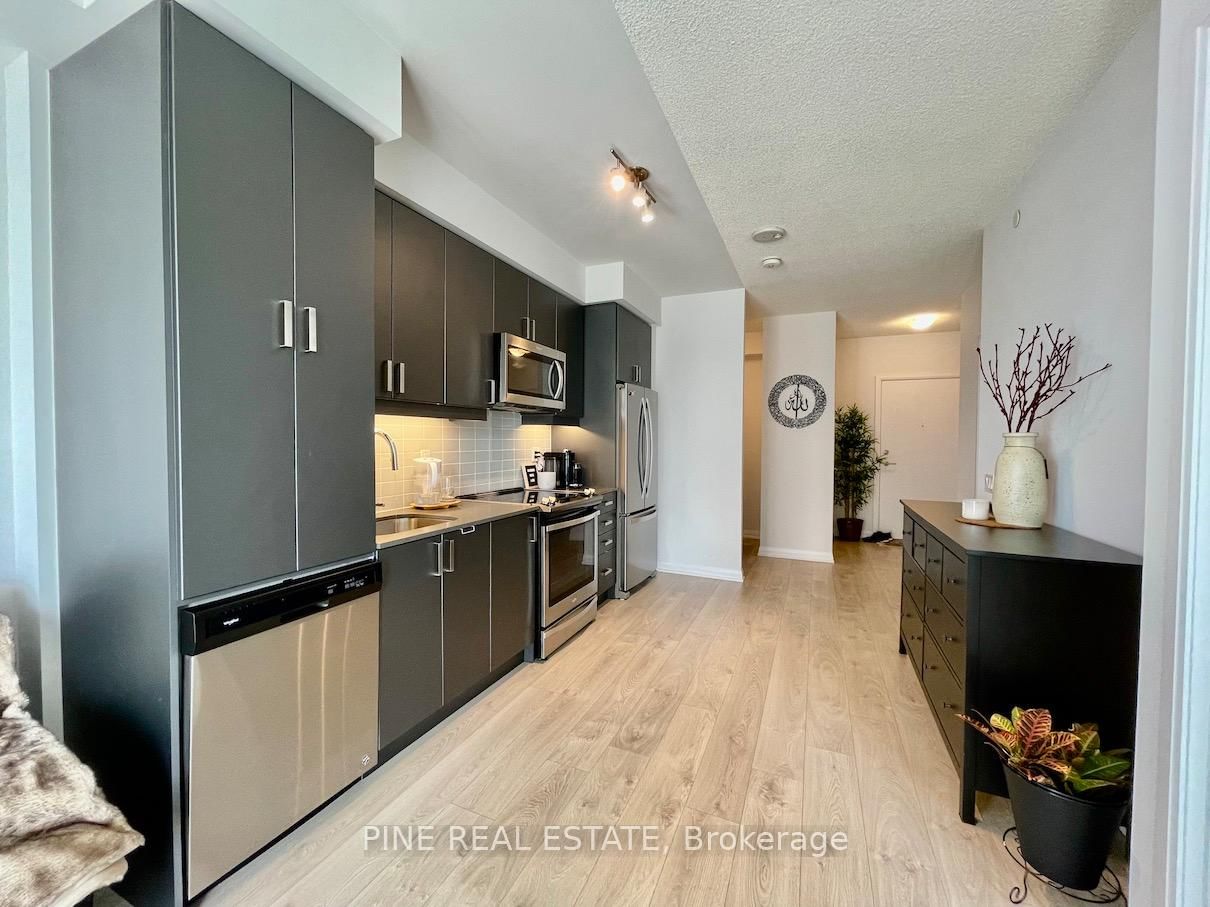 Welcome to The Met Condos by Plaza Corp, located in the heart of Vaughan at 7895 Jane Street. This 1-bedroom plus den unit features 2 full washrooms and a spacious, open-concept layout with high ceilings and a large west-facing balcony, offering abundant natural light. The unit boasts quality finishes throughout, including upgraded cabinetry and countertops, stainless steel appliances, and neutral decor. Residents of The Met enjoy a variety of amenities, such as a fitness center, spa with whirlpools, yoga studios, private dining rooms, lounge and bar, theatre room, games room, tech lounge, and 24-hour concierge service. The building is centrally located with immediate access to major highways, and public transit, including the Vaughan Metropolitan Centre Subway Station, shopping, and restaurants. This unit includes one parking space and one locker for your convenience. According to Walk Score, the property has a Walk Score of 55, indicating that some errands can be accomplished on foot. The Transit Score is 74, reflecting excellent transit options nearby. The Bike Score is 51, suggesting that the area is somewhat bikeable.